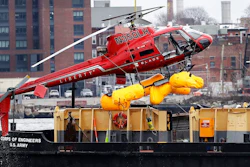 In this March 12, 2018 file photo, a helicopter, which crashed the previous day, is hoisted by crane from the East River onto a barge, in New York. The helicopter company, FlyNYON, exploited a regulatory loophole to avoid stricter safety requirements, federal investigators said Tuesday, Dec. 10, 2019.