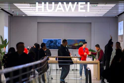 In this Nov. 20, 2019, photo, customers shop at a Huawei store at a shopping mall in Beijing. The founder of Huawei says the Chinese tech giant is moving its U.S. research center to Canada due to American restrictions on its activities.