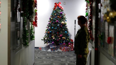 A decorated tree stands in the NORAD Tracks Santa Center at Peterson Air Force Base, Monday, Dec. 23, 2019, in Colorado Springs, Colo. More than 1,500 volunteers will handle an estimated 140,000 telephone inquiries from around the globe from children and their parents on the whereabouts of Santa Claus on Christmas Eve.