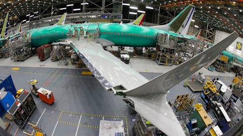 In this March 27, 2019, photo taken with a fish-eye lens, a Boeing 737 MAX 8 airplane sits on the assembly line during a brief media tour in Boeing's 737 assembly facility in Renton, Wash. The looming production shutdown of Boeing 737 Max jets is taking a toll on a key supplier. Spirit AeroSystems Holdings Inc. is asking employees if they will take voluntarily buyouts. Spirit suspended production of fuselages and other parts for the Max on Jan. 1, 2020, after Boeing told the Wichita, Kansas, company to suspend shipments.