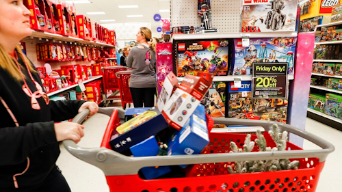 In this Nov. 23, 2018, file photo shoppers browse the aisles during a Black Friday sale at a Target store in Newport, Ky. Comparable stores sales at Target fell well below the previous year, joining a growing list of retailers reporting a meager performances during the critical holiday shopping season. Target said Wednesday, Jan. 15, 2020, that it had weaker-than-expected sales of electronics, toys and some home good. Those sales climbed 1.4% in the November-December period, compared with a 5.7% increase a year earlier.