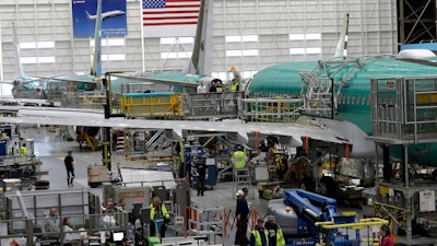 This March 27, 2019 file photo shows people working on the Boeing 737 MAX 8 assembly line during a brief media tour in Boeing's 737 assembly facility in Renton, WA.