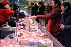 People shop for meat a supermarket in Handan in northern China's Hebei Province on Thursday, Jan. 9.