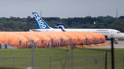 In this Oct. 3, 2019 file photo, completed Boeing 737 MAX fuselages, made at Spirit Aerosystems in Wichita, KS, sit covered in tarps near the factory.