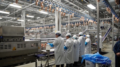 In this Dec. 12, 2019 file photo, workers process chickens at the Lincoln Premium Poultry plant, Costco Wholesale's dedicated poultry supplier, in Fremont, NE.