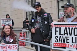 In this Jan. 13 file photo, Matthew Elliot, center, and other supporters of flavored vaping products protest at the state house in Trenton, NJ.
