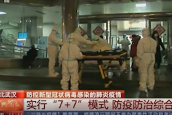In this Thursday, Jan. 23 image from China's CCTV video, a patient is carried on a stretcher to an ambulance by medical workers in protective suits in Wuhan, China. China is swiftly building a hospital dedicated to treating patients infected with a new virus that sickened hundreds and prompted unprecedented lockdowns of cities home to millions of people during the country's most important holiday.