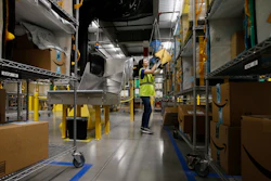 In this Dec. 17, 2019, file photo Jocelyn Nieto stows packages into special containers after Amazon robots deliver separated packages by zip code at an Amazon warehouse facility in Goodyear, AR.