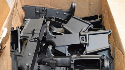 This photo provided by the U.S. Department of Justice shows AR-15 lower receivers, which federal agents have seized, including these unfinished ones taken in 2014 in California, for firearms investigations nationwide. For decades, the federal government has treated the mechanism called the lower receiver as the essential piece of the semiautomatic rifle, which has been used in some of the nation's deadliest mass shootings. But some defense attorneys have recently argued that the part alone does not meet the definition in the law.