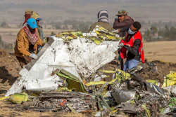 In this file photo dated Monday, March 11, 2019, rescuers work at the scene of an Ethiopian Airlines plane crash south of Addis Ababa, Ethiopia.