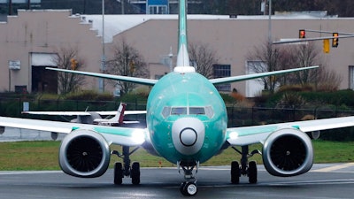 In this Dec. 11, 2019, file photo, a Boeing 737 Max airplane being built for Norwegian Air International turns as it taxis for take off for a test flight at Renton Municipal Airport in Renton, Wash. Boeing faces a growing checklist of items it could be forced to fix before federal safety officials let the grounded 737 Max airliner fly again. The Federal Aviation Administration recently asked Boeing to review all possible ramifications of the changes it is making on the plane.