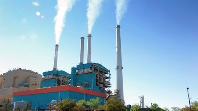 In this July 1, 2013, file photo, gas emissions rises from a coal-burning power plant in Colstrip, Mont. One of the largest coal-fired power plants in the western U.S. will close two of its four units by Saturday, Jan. 4, 2020, as the Montana facility edges toward an eventual total shutdown.