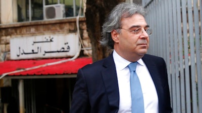 Carlos Abou Jaoude, a lawyer for ex-Nissan chief Carlos Ghosn, leaves the judicial palace where Ghosn was questioned by a Lebanese prosecutor, in Beirut, Lebanon, Thursday, Jan. 9, 2020. Lebanese prosecutors issued a travel ban for fugitive ex-Nissan chief Carlos Ghosn, following an Interpol-issued notice, a judicial official said Thursday.