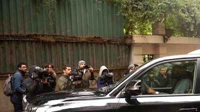 Journalists film a vehicle leaving the house of ex-Nissan chief Carlos Ghosn in Beirut, Lebanon, Friday, Jan. 3, 2020. The former Nissan Motor Co. Chairman fled Japan this week while awaiting trial on financial misconduct charges and appeared in Lebanon.