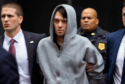 In this Dec. 17, 2015, file photo, Martin Shkreli, center, the former hedge fund manager under fire for buying a pharmaceutical company and ratcheting up the price of a life-saving drug, is escorted by law enforcement agents in New York after being taken into custody following a securities probe. State and federal authorities sued the imprisoned drug entrepreneur Monday, Jan. 27, 2020, over business tactics that helped make him the bad-boy face of profiteering in the pharmaceuticals industry, seeking to bar the so-called 'Pharma Bro' from the industry for life.