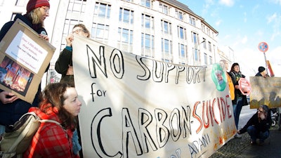 Activist of 'Extinction Rebellion' and 'Parents for Future Berlin' attend a protest rally against the climate policy of Australia's government in front of Australia's embassy in Berlin, Germany, Friday, Jan. 10, 2020.