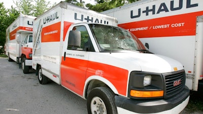 In this June 14, 2006 file photo are U-Haul trucks sit on a dealer lot in Des Moines, Iowa. U-Haul has a New Year's resolution: cut down on hiring people who smoke. The moving company said that it won't hire nicotine users in the 21 states where it is legal to do so, saying that it wants to ensure a 'healthier workforce.' The new policy will start Feb. 1, 2020. and won't apply to those hired before then.