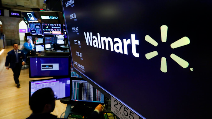 In this Feb. 18, 2020 file photo, the logo for Walmart appears above a trading post on the floor of the New York Stock Exchange. Walmart is confirming that it's developing a competitor to Amazon's juggernaut Prime membership program. The company declined on Thursday, Feb. 27 to offer details, but a spokeswoman said it will be called Walmart+.