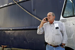In this Oct. 14, 201, file photo, Carlos Rafael talks on the phone at Homer's Wharf near his herring boat F/V Voyager in New Bedford, MA. A Massachusetts company is slated to acquire in 2020 what's left of the boats once owned by Rafael, who was forced out of the industry after an elaborate fraud. The fishing magnate, known as the Codfather, was sentenced in 2017 to nearly four years in prison after pleading guilty to evading fishing quotas and smuggling money to Portugal. (