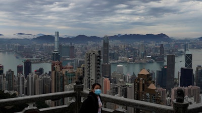 A woman wears protective face mask at the Peak, a popular tourist spot in Hong Kong on Thursday, Feb. 13. COVID-19 viral illness has sickened tens of thousands of people in China since December.