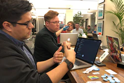 In this Monday, Jan. 13, 2020, photograph taken in Denver, software engineer David Viramontes, front, and digital strategist Patrick Collins direct a meeting of Code For Denver.