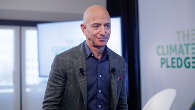 In this Thursday, Sept. 19, 2019 file photo, Amazon CEO Jeff Bezos walks off stage after holding a news conference at the National Press Club in Washington to announce the Climate Pledge, setting a goal to meet the Paris Agreement 10 years early.