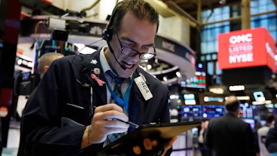 Trader Gregory Rowe works on the floor of the New York Stock Exchange on Monday, Feb. 24.