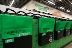 In this Feb. 21, 2020 photo, reusable shopping bags are displayed inside an Amazon Go Grocery store set to open soon in Seattle's Capitol Hill neighborhood.