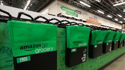 In this Feb. 21, 2020 photo, reusable shopping bags are displayed inside an Amazon Go Grocery store set to open soon in Seattle's Capitol Hill neighborhood.