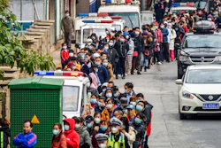 In this Jan. 29 file photo, people line up to buy face masks from a medical supply company in Nanning in southern China's Guangxi Zhuang Autonomous Region. Fear of the spreading coronavirus has led to a global run on sales of face masks despite medical experts' advice that most people who aren't sick don't need to wear them.