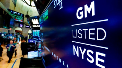 In this April 23, 2018, file photo, the logo for General Motors appears above a trading post on the floor of the New York Stock Exchange. Despite a 40-day strike by factory workers and slumping sales in the U.S. and China, General Motors still made money in 2019. The company posted a $6.58 billion profit for the year, but that was down almost 17% from 2018.