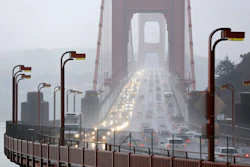 In this Jan. 5, 2016, file photo, traffic crosses the Golden Gate Bridge in the rain in this view from Sausalito, Calif. The Trump administration has ended its antitrust probe into a deal between California and four big automakers, after failing to find that the companies' conduct violated the law.