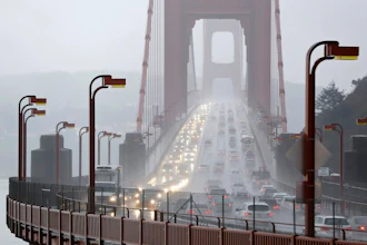 In this Jan. 5, 2016, file photo, traffic crosses the Golden Gate Bridge in the rain in this view from Sausalito, Calif. The Trump administration has ended its antitrust probe into a deal between California and four big automakers, after failing to find that the companies' conduct violated the law.