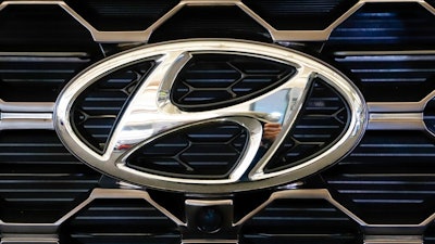 This Feb. 14, 2019 file photo shows the Hyundai logo on a 2019 Hyundai Santa Fe SUV on display at the 2019 Pittsburgh International Auto Show in Pittsburgh. Hyundai is recalling nearly 430,000 small cars because water can get into the antilock brake computer, cause an electrical short and possibly an engine fire. The latest recall covers certain 2006 through 2011 Elantra and 2007 through 2011 Elantra Touring vehicles.