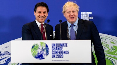 Britain's Prime Minister Boris Johnson, right, and Italy's Prime Minister Giuseppe Conte attend the launch of the upcoming UK-hosted COP26 UN Climate Summit in London, Tuesday Feb. 4, 2020, that will take place in autumn 2020 in Glasgow, Scotland. Johnson is expected to announce a target to stop selling new petrol and diesel vehicles by 2035, including hybrid vehicles for the first time.