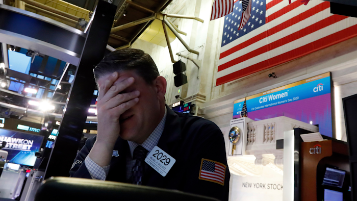 Trader Michael Gallucci prepares for the day's activity on the floor of the New York Stock Exchange on Monday, March 9.