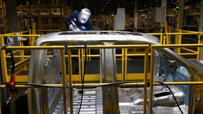 In this Nov. 11, 2014 photo, Ron Hudgins welds a 2015 Ford F-150 cab at the Dearborn Truck Plant in Dearborn, Mich.