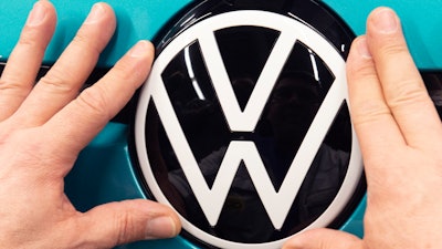 A worker completes an electric car ID.3 body at the assembly line during a press tour at the plant of the German manufacturer Volkswagen AG (VW) in Zwickau, eastern Germany, Tuesday, Feb. 25, 2020.