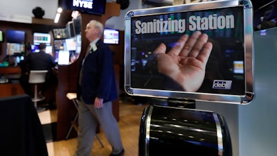 A trader passes a hand sanitizing station on the floor of the New York Stock Exchange on Tuesday, March 3. Federal Reserve Chairman Jerome Powell noted that the coronavirus 'poses evolving risks to economic activity.'