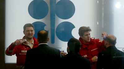 Austrian rescue personnel checks the body temperature of participants before meeting of the Organization of the Petroleum Exporting Countries, OPEC at their headquarters in Vienna, Austria, Thursday, March 5, 2020.