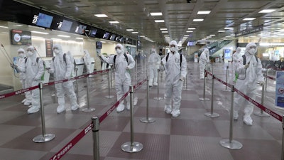 South Korean army soldiers wearing protective suits spray disinfectant to prevent the spread of the new coronavirus at Daegu International Airport in Daegu, South Korea on Friday, March 6.