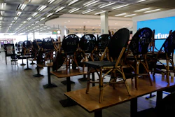 Chairs pile up at cafe at Orly airport Tuesday, March 17, 2020, south of Paris.