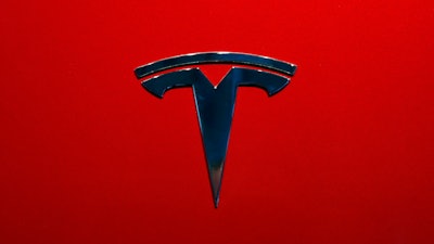 This Oct. 3, 2018, file photo shows the logo of Tesla Model 3 at the Auto show in Paris.