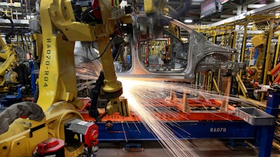 In this May 19, 2011 photo, robots weld a Chevrolet Sonic at the General Motors Orion Assembly plant in Orion Township, MI.