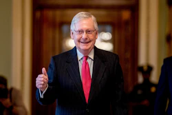 Senate Majority Leader Mitch McConnell of Ky. gives a thumbs up as he leaves the Senate chamber on Capitol Hill in Washington, Wednesday, March 25, 2020
