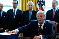 President Donald Trump speaks before he signs the coronavirus stimulus relief package in the Oval Office at the White House on Friday, March 27 in Washington.