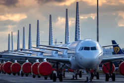 Vueling Airlines planes sit parked in a line at the Seville, Spain airport on Saturday, March 21, 2020, idled due to the COVID-19 coronavirus outbreak.