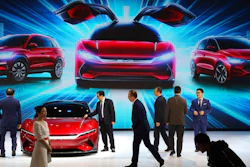 In this April 16, 2019, file photo, attendees take a close look at cars from BYD at the Auto Shanghai 2019 show in Shanghai. China’s auto sales plunged 81.7% in February, 2020, from a year ago after Beijing shut down much of the economy to fight a virus outbreak, adding to problems for an industry that already was struggling with shrinking demand.