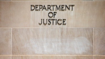 In this June 19, 2015, file the Justice Department Building in Washington. The Justice Department says pharmaceutical company Sandoz Inc. will pay a $195 million penalty to resolve criminal charges of conspiring to fix prices and rig bids for generic drugs. Officials say Monday, March 2, 2020, that the company would admit guilt and pay the penalty.