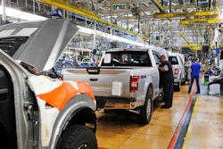 In this Sept. 27, 2018, file photo a United Auto Workers assemblymen work on a 2018 Ford F-150 trucks being assembled at the Ford Rouge assembly plant in Dearborn, Mich.